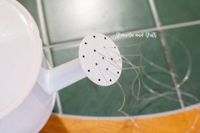 Granola and Grits Blog- DIY Watering Can Suncatcher- threading strings